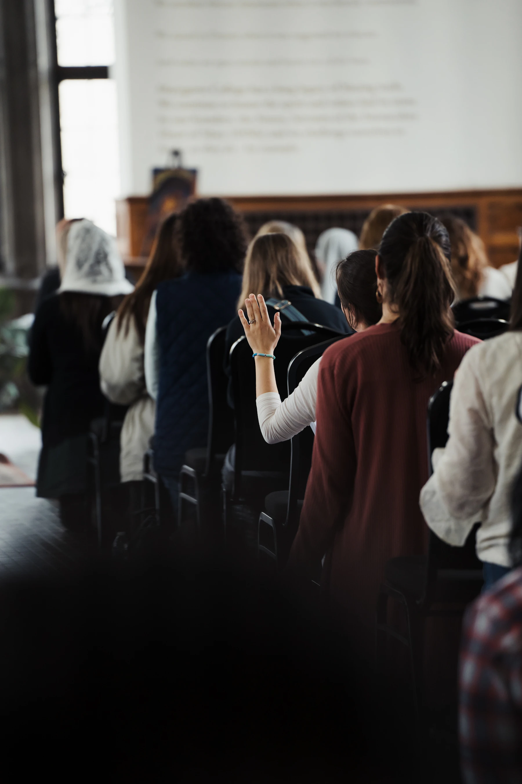 A participant raising a hand in worship